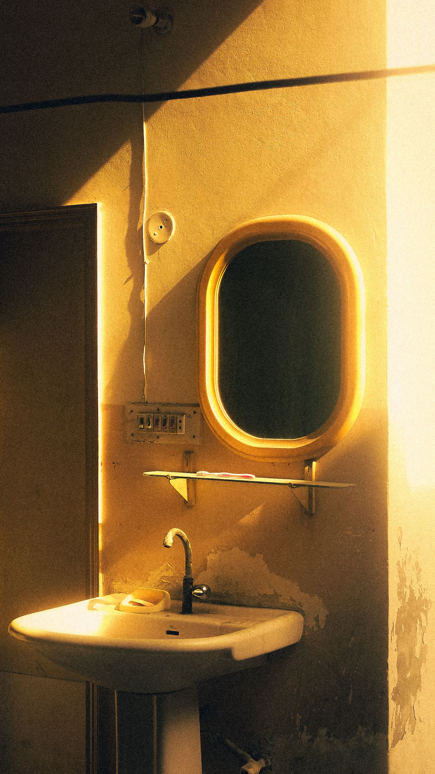 A warmly lit bathroom mirror in early morning light