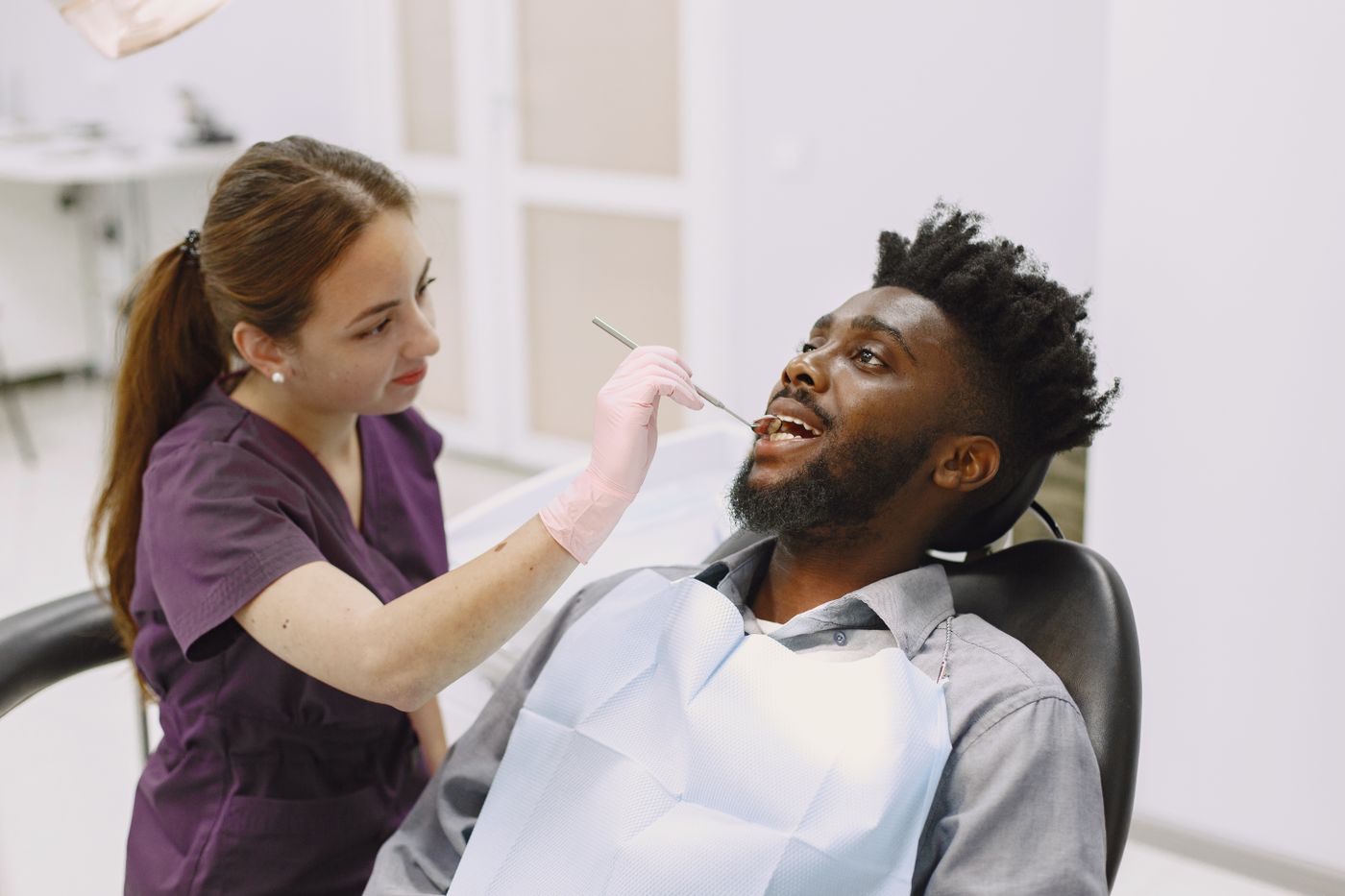 A dentist examining a patient in a modern clinic