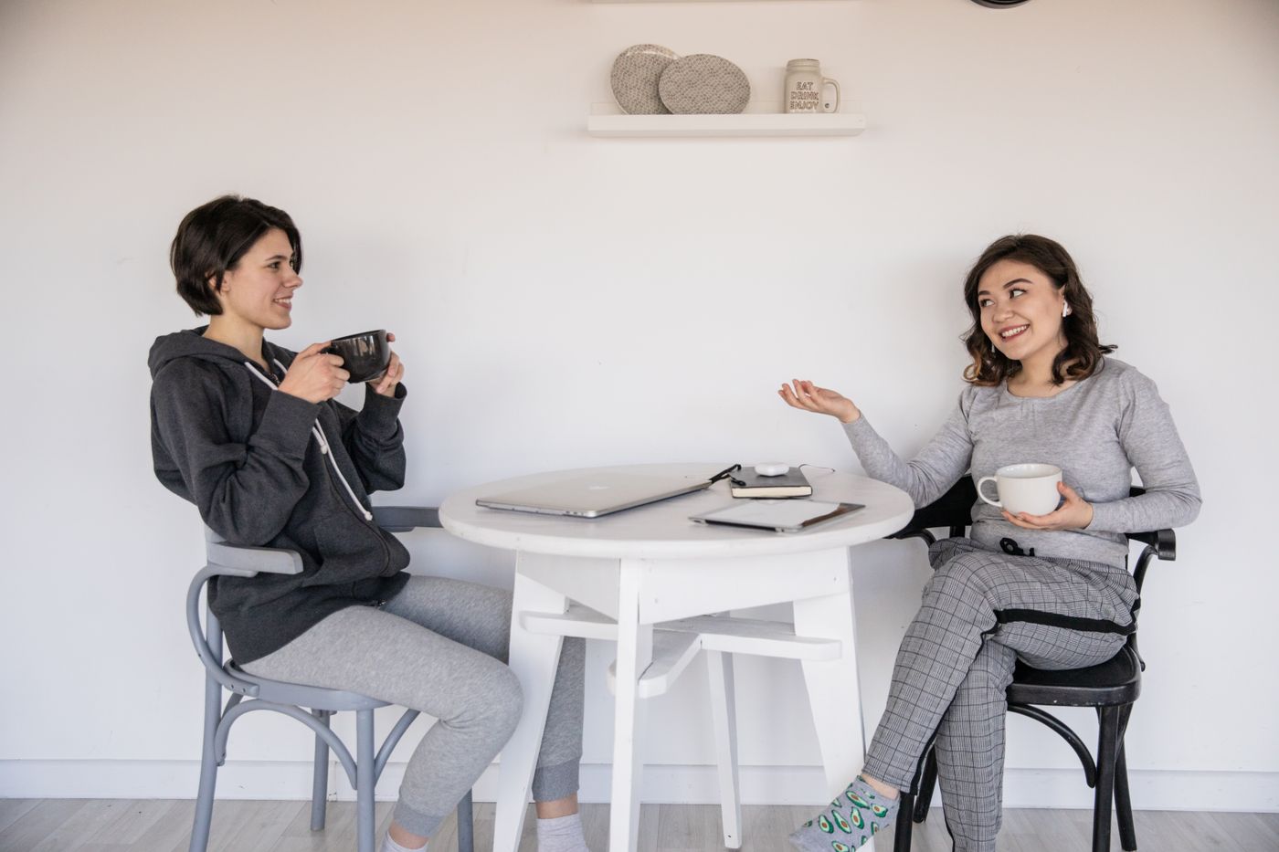 Two women talking over coffee at a kitchen table
