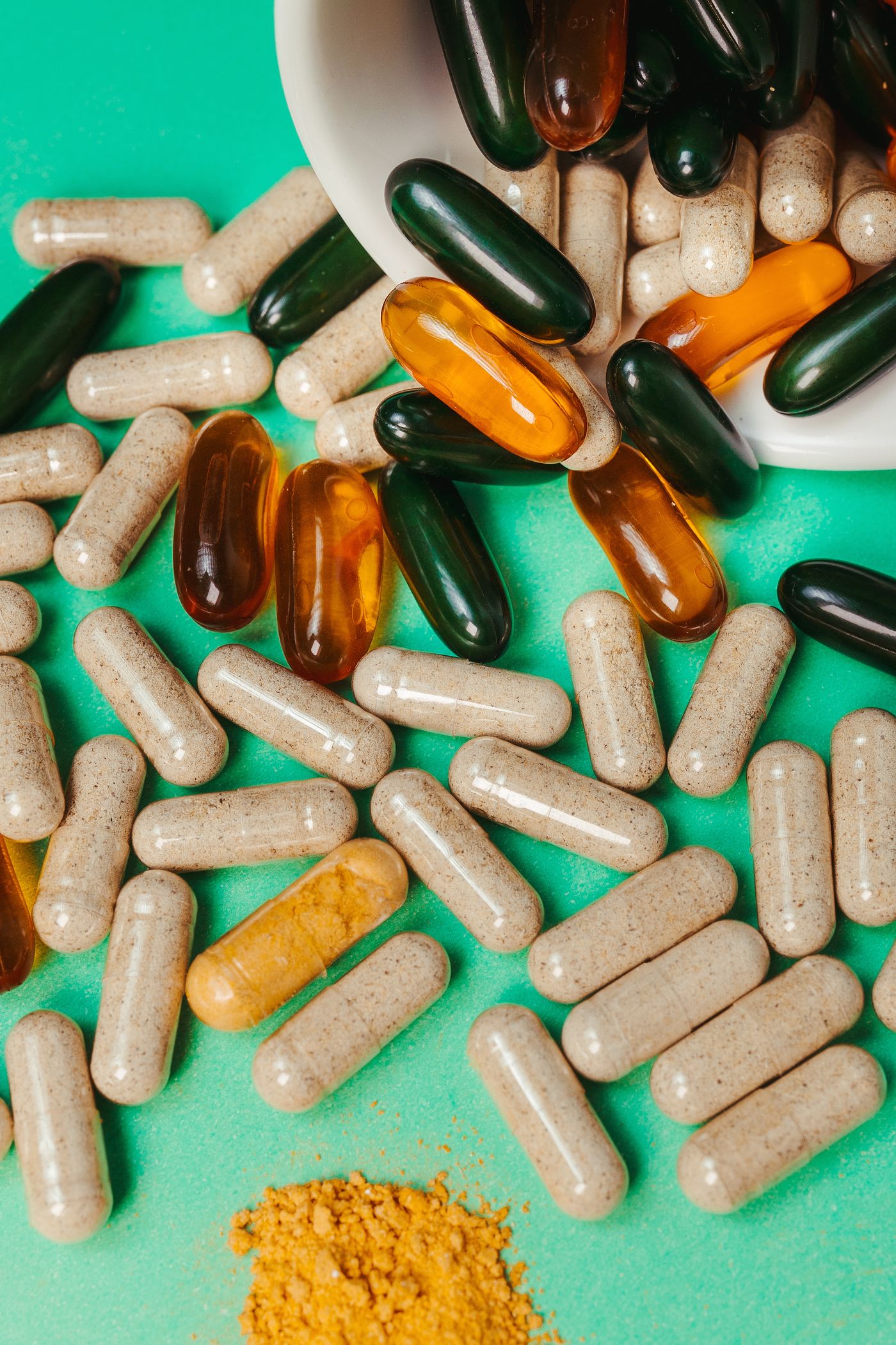 An assortment of capsules on a green background